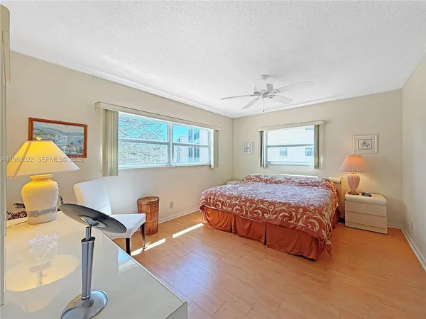 a bathroom with a granite countertop toilet sink and mirror