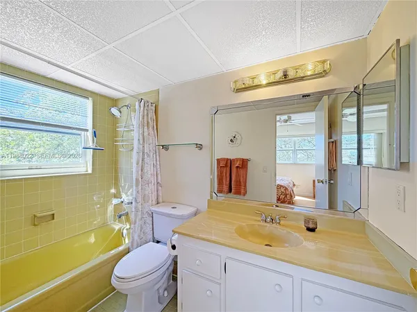 a spacious bedroom with a bed and a chandelier