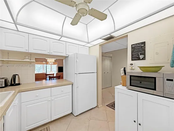 a dining room with furniture a chandelier and wooden floor