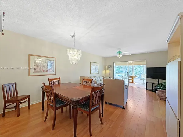 a view of a hallway with furniture and wooden floor