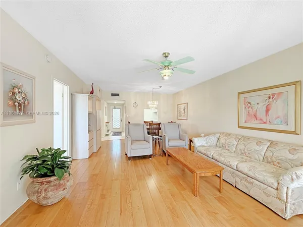 a living room with furniture and large windows