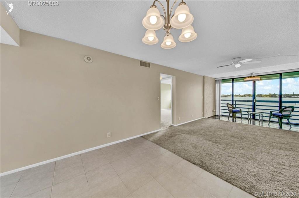 1950 Southwest Palm City Road, Unit 13305 Stuart, FL 34994 - Photo 11 of 28 an empty room with windows and ceiling fan