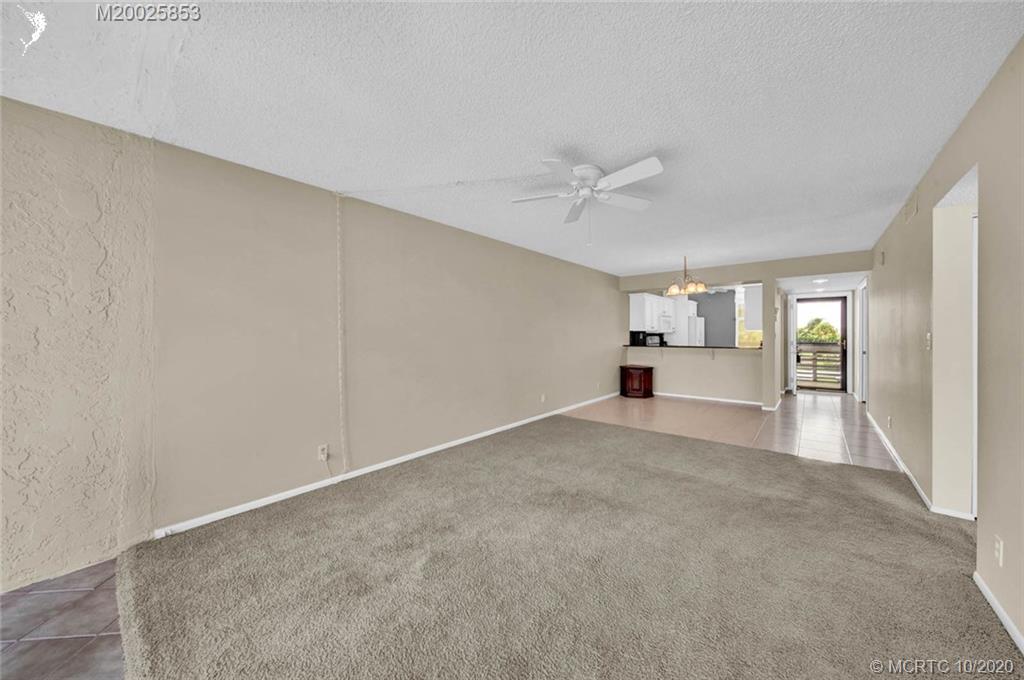 1950 Southwest Palm City Road, Unit 13305 Stuart, FL 34994 - Photo 13 of 28 a view of empty room with a fireplace