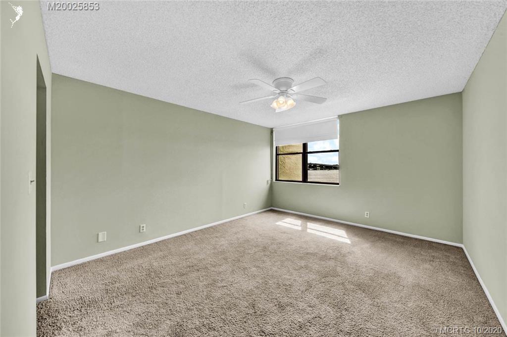 1950 Southwest Palm City Road, Unit 13305 Stuart, FL 34994 - Photo 16 of 28 an empty room with windows and ceiling fan