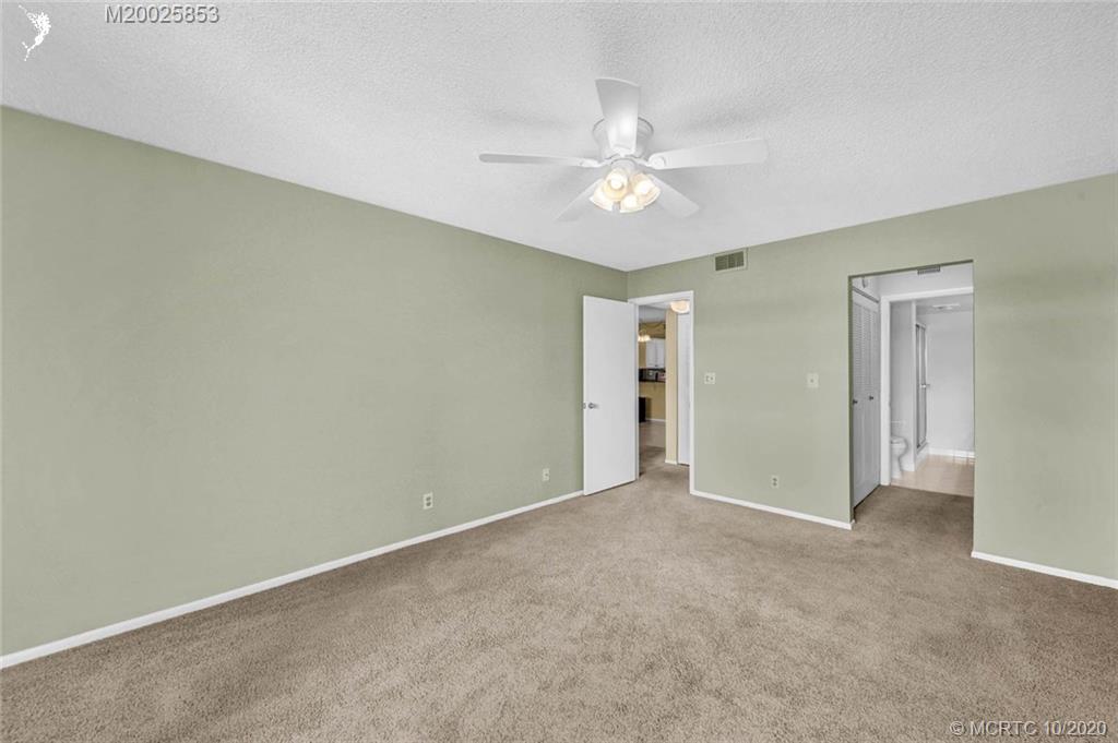 1950 Southwest Palm City Road, Unit 13305 Stuart, FL 34994 - Photo 18 of 28 a view of an empty room with a fan