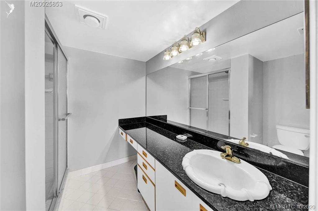 1950 Southwest Palm City Road, Unit 13305 Stuart, FL 34994 - Photo 20 of 28 a bathroom with a sink double vanity and a mirror