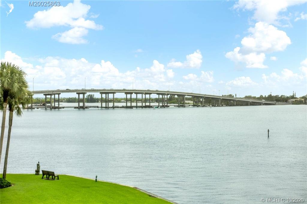 1950 Southwest Palm City Road, Unit 13305 Stuart, FL 34994 - Photo 2 of 28 a view of a lake with houses
