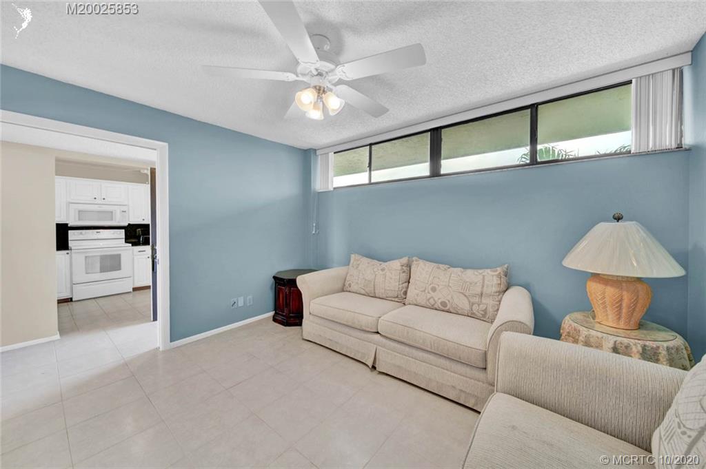 1950 Southwest Palm City Road, Unit 13305 Stuart, FL 34994 - Photo 22 of 28 a living room with furniture and a chandelier