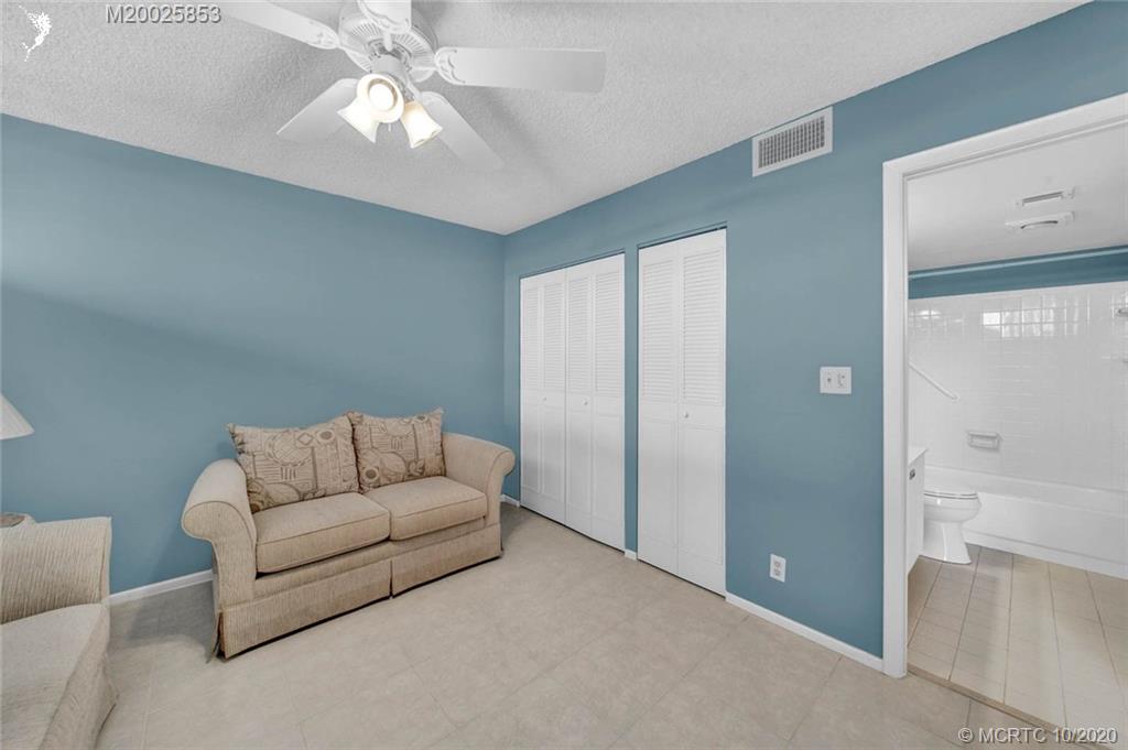 1950 Southwest Palm City Road, Unit 13305 Stuart, FL 34994 - Photo 23 of 28 a living room with furniture and a chandelier