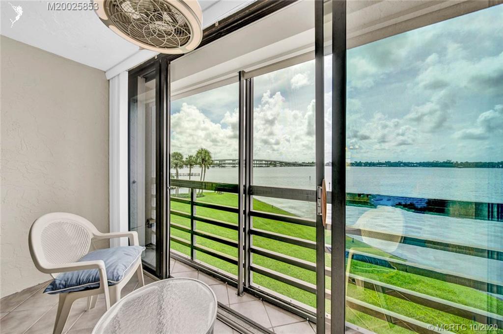 1950 Southwest Palm City Road, Unit 13305 Stuart, FL 34994 - Photo 26 of 28 a living room with furniture and a floor to ceiling window