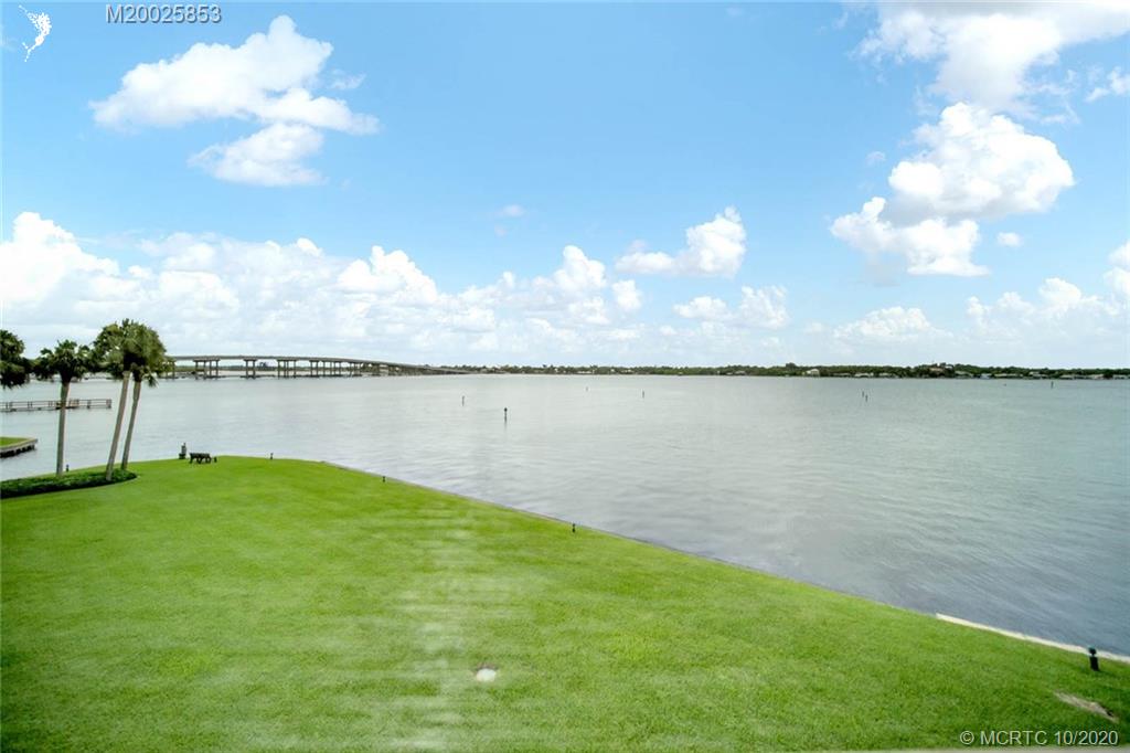 1950 Southwest Palm City Road, Unit 13305 Stuart, FL 34994 - Photo 27 of 28 a view of a lake with houses in the back