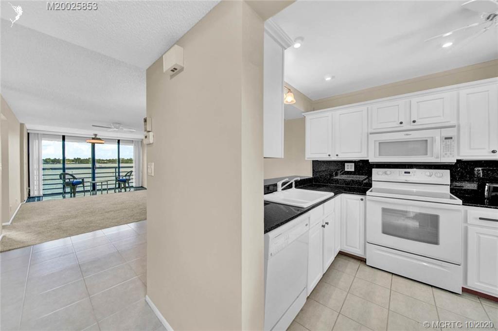 1950 Southwest Palm City Road, Unit 13305 Stuart, FL 34994 - Photo 6 of 28 a kitchen with a sink stove and cabinets
