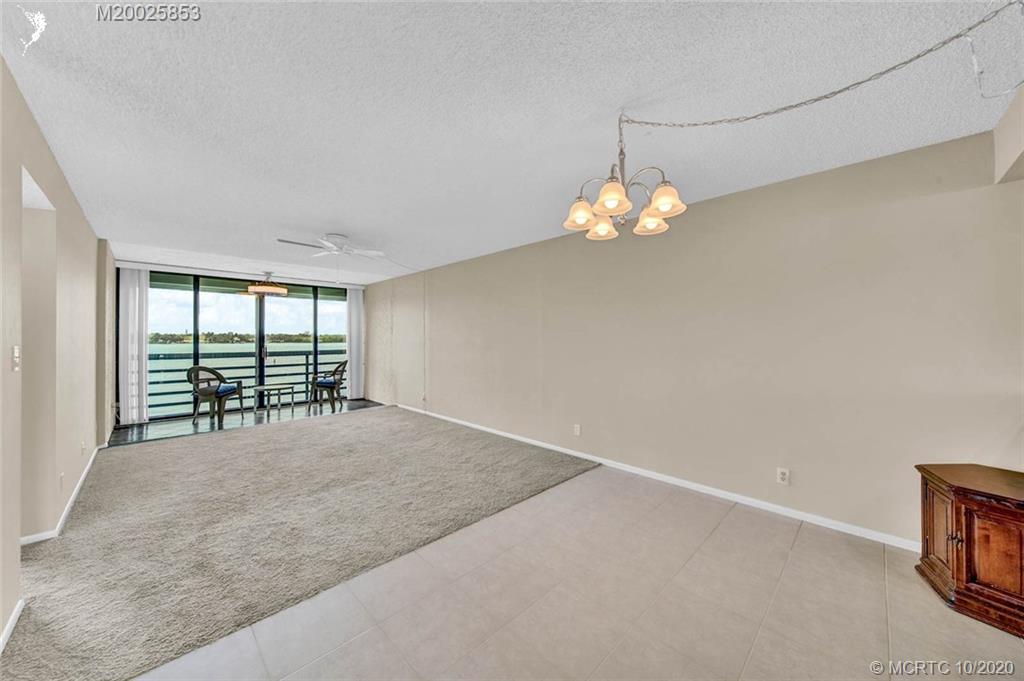 1950 Southwest Palm City Road, Unit 13305 Stuart, FL 34994 - Photo 10 of 28 a view of a livingroom with a ceiling fan and window