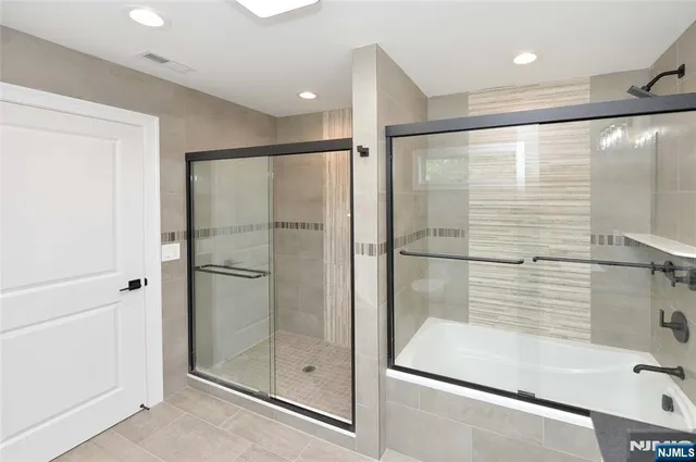 a bathroom with a glass shower door