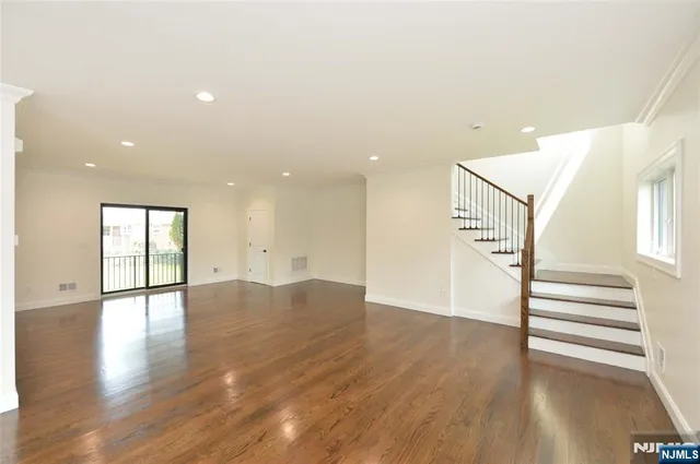 a view of an entryway with wooden floor