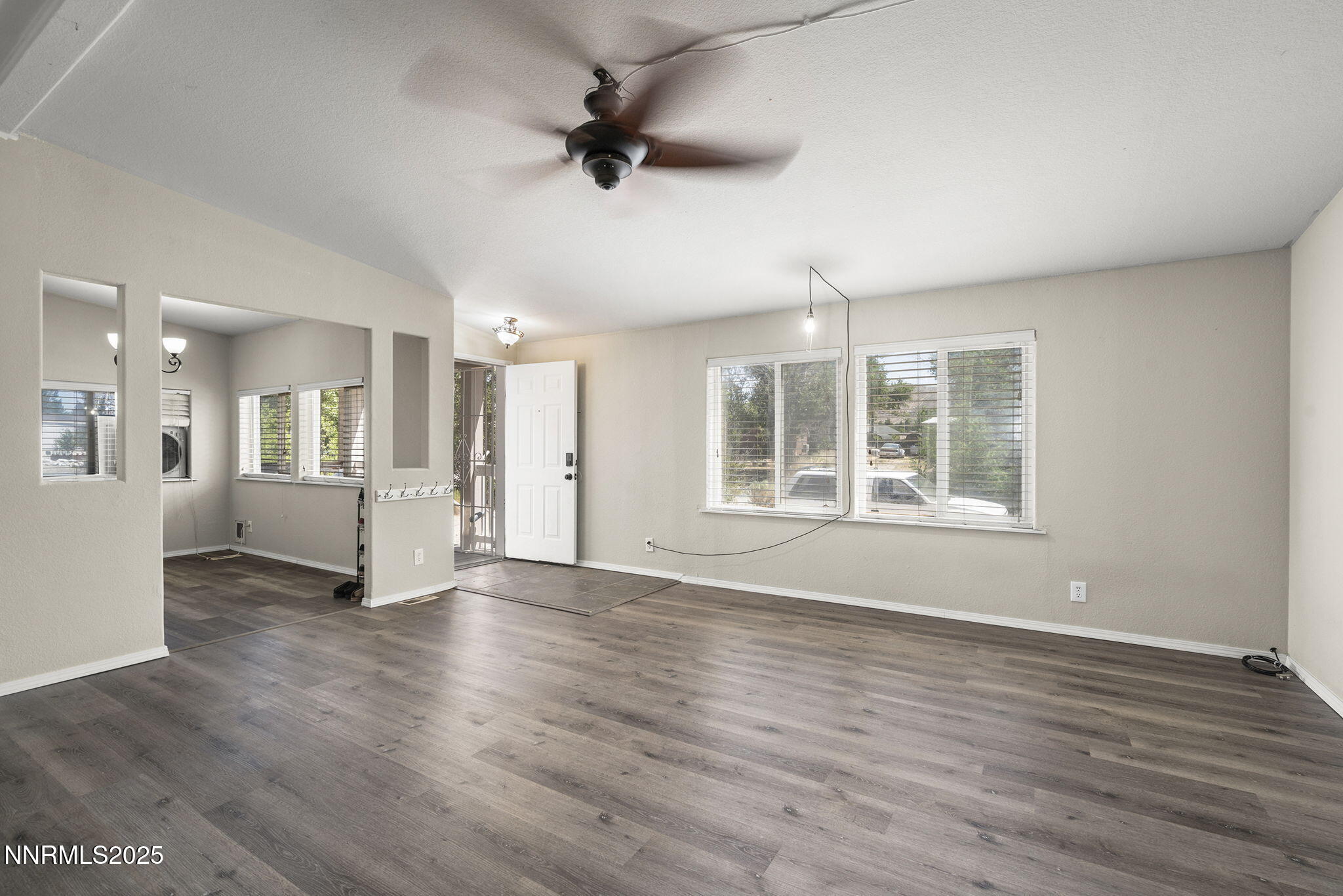 3665 Hummingbird Drive Reno, NV 89508 - Photo 8 of 21 a view of an empty room with a window and wooden floor