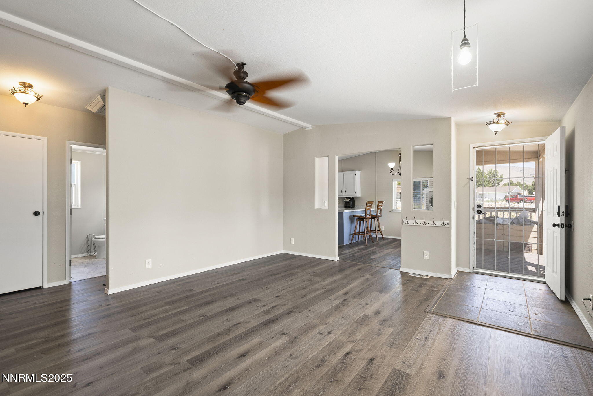 3665 Hummingbird Drive Reno, NV 89508 - Photo 9 of 21 a view of a hallway with wooden floor and a kitchen