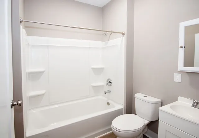 a bathroom with a bathtub a toilet and a shower