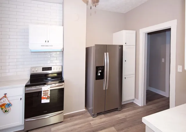 a kitchen with stainless steel appliances a refrigerator stove and sink