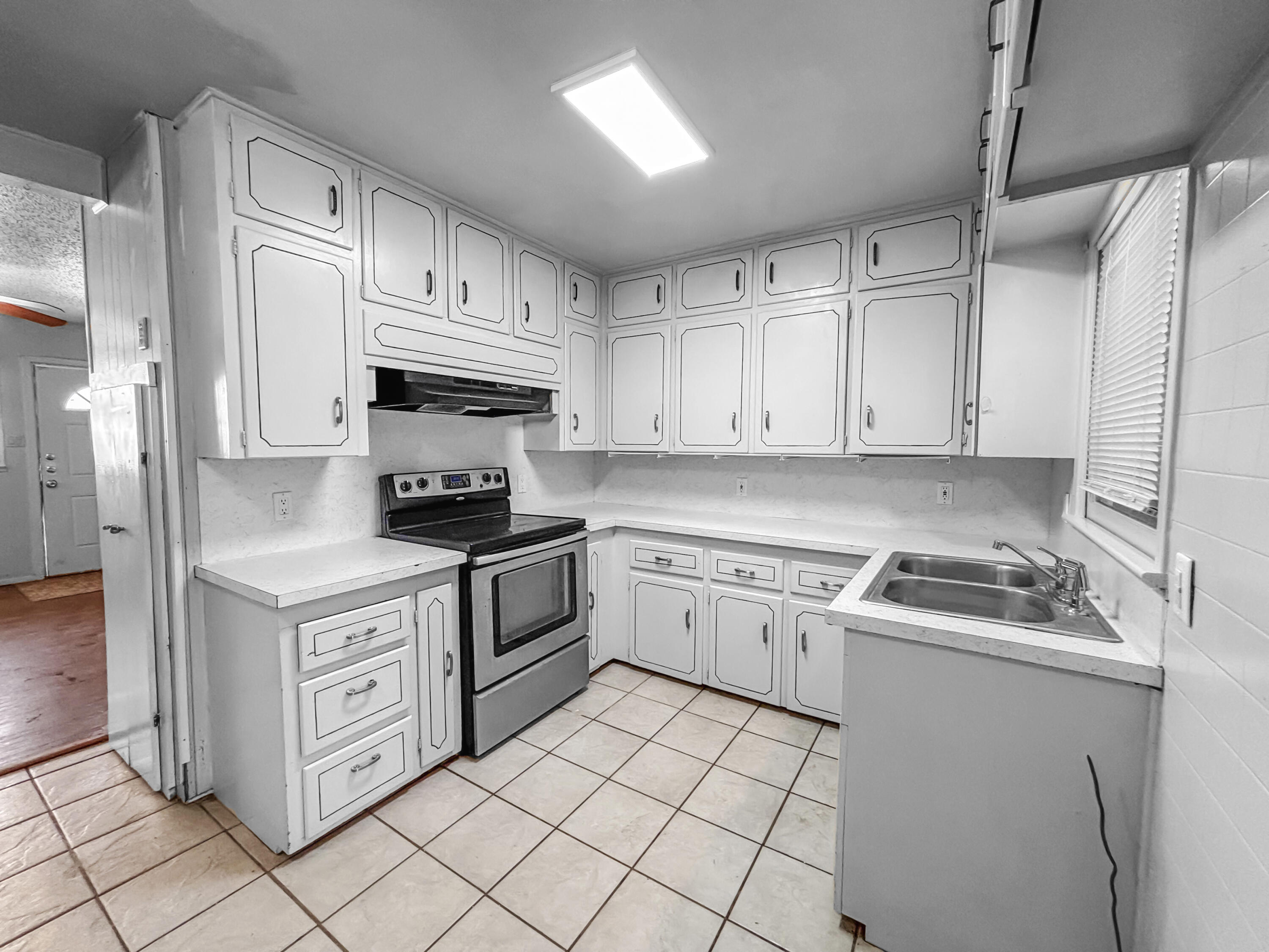 4411 45th Street Lubbock, TX 79414 - Photo 11 of 44 a kitchen with white cabinets stainless steel appliances and sink