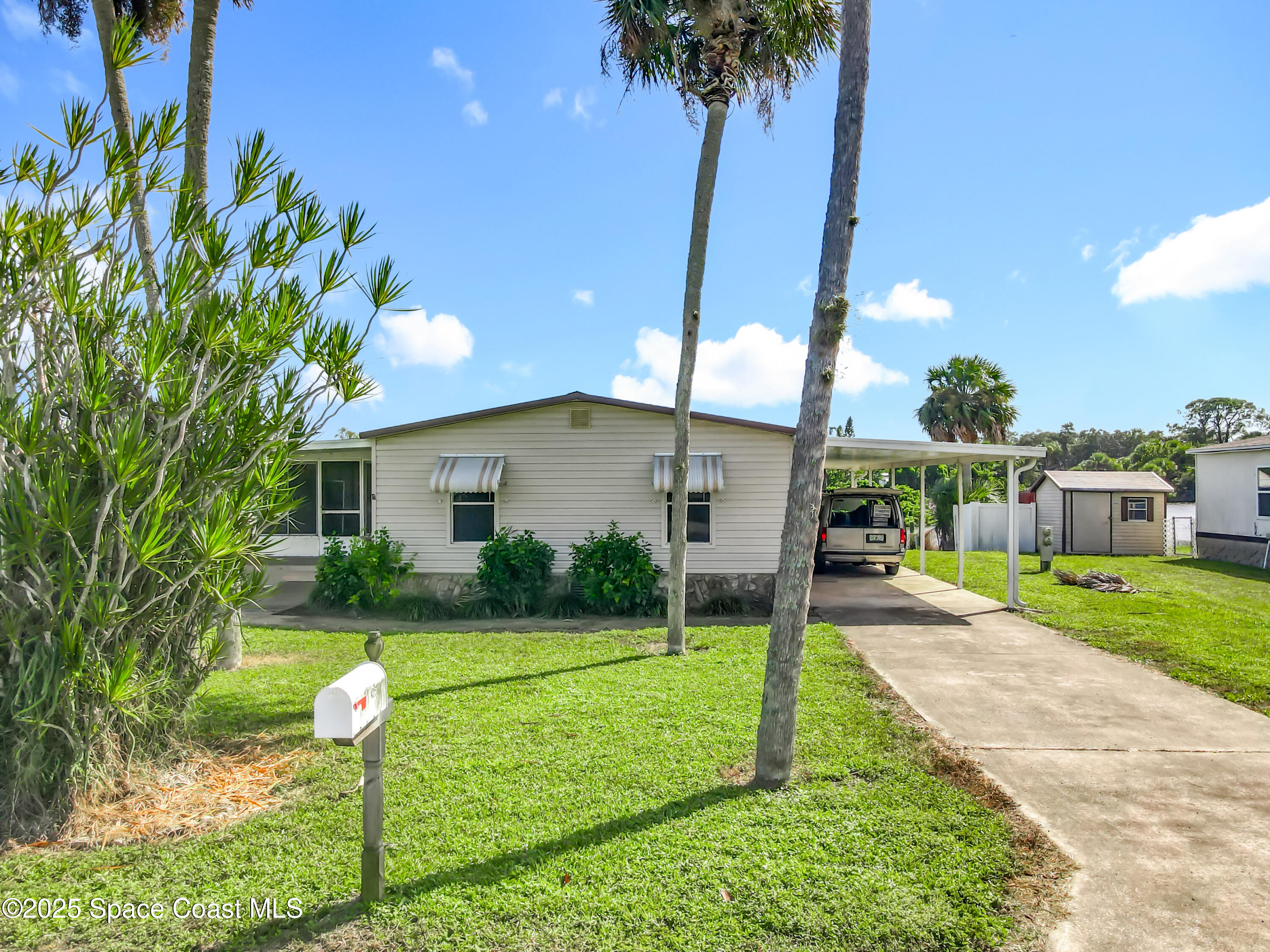 425 Baker Road Merritt Island, FL 32953 - Photo 1 of 27 a view of a house with backyard and a tree