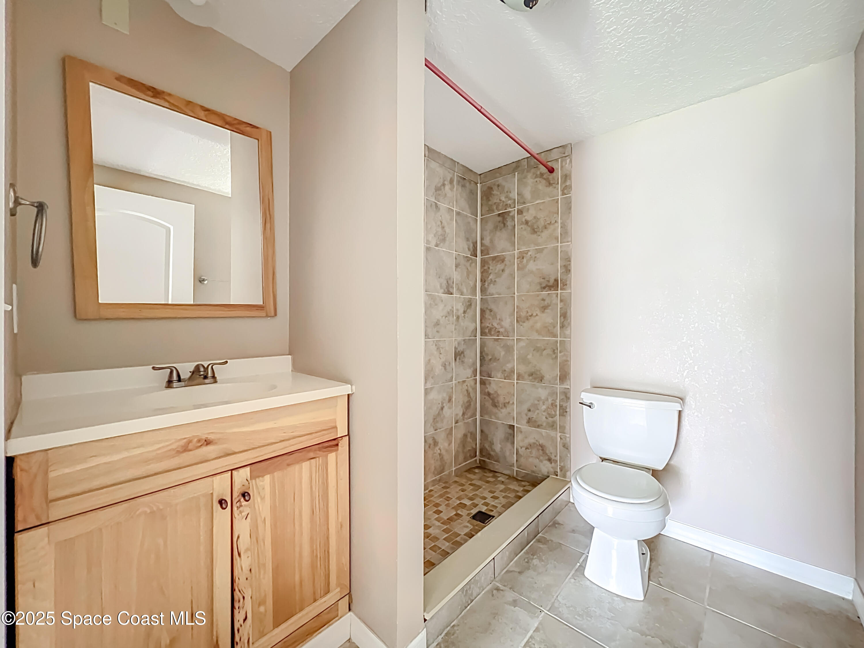 425 Baker Road Merritt Island, FL 32953 - Photo 14 of 27 a bathroom with a sink toilet and shower