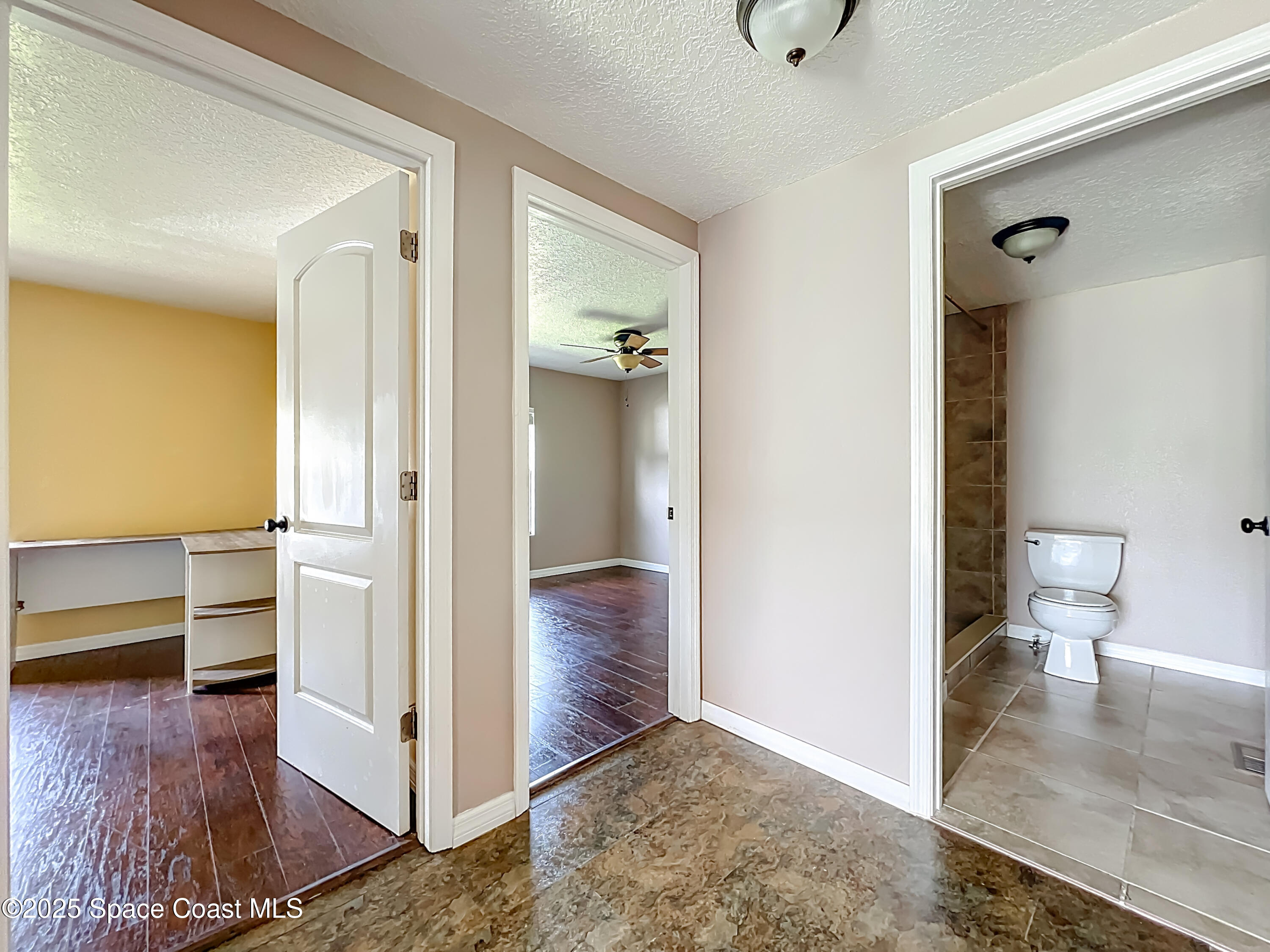 425 Baker Road Merritt Island, FL 32953 - Photo 15 of 27 a view of a hallway with bathroom and wooden floor