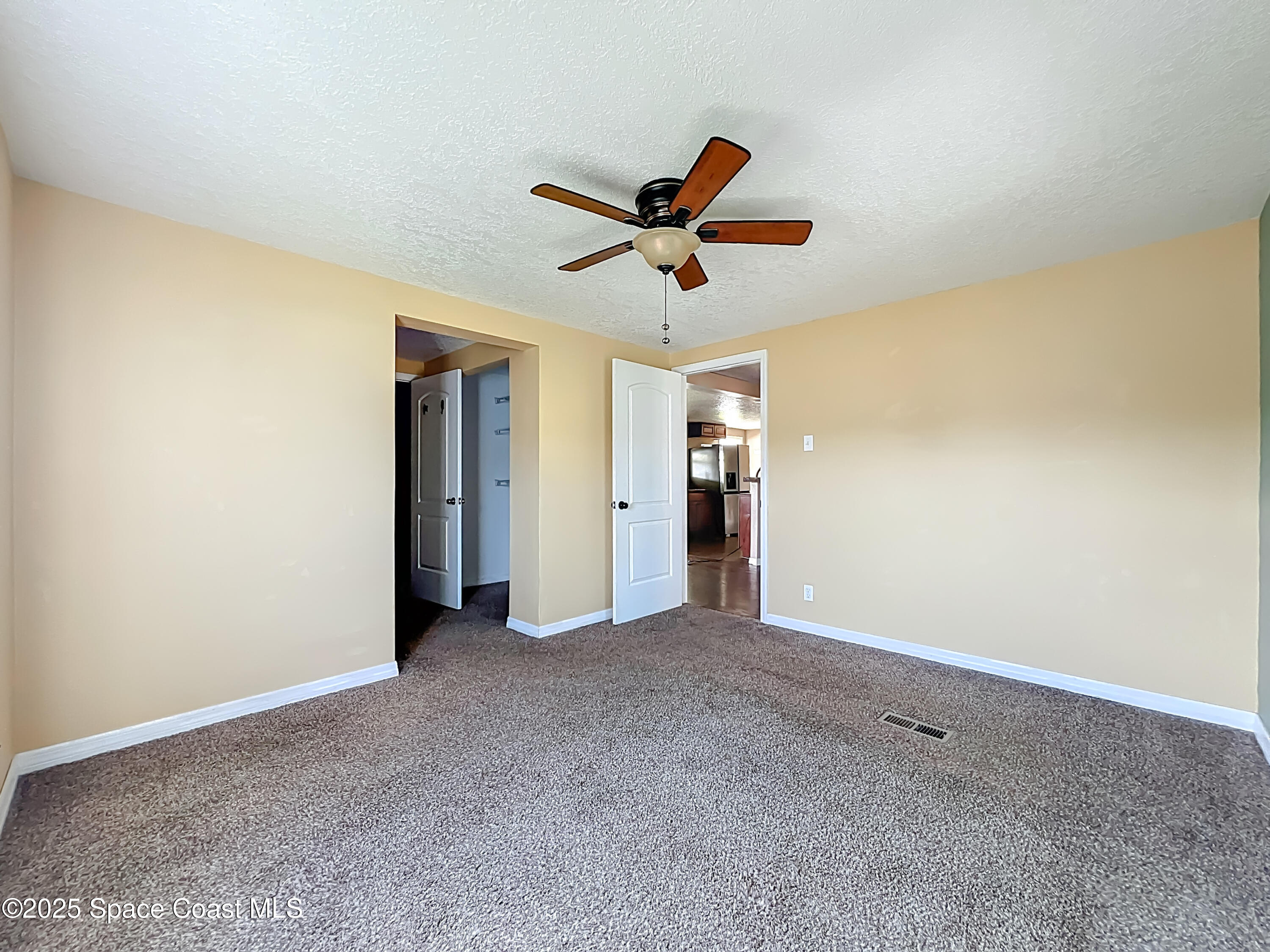 425 Baker Road Merritt Island, FL 32953 - Photo 16 of 27 a view of a big room with closet and ceiling fan