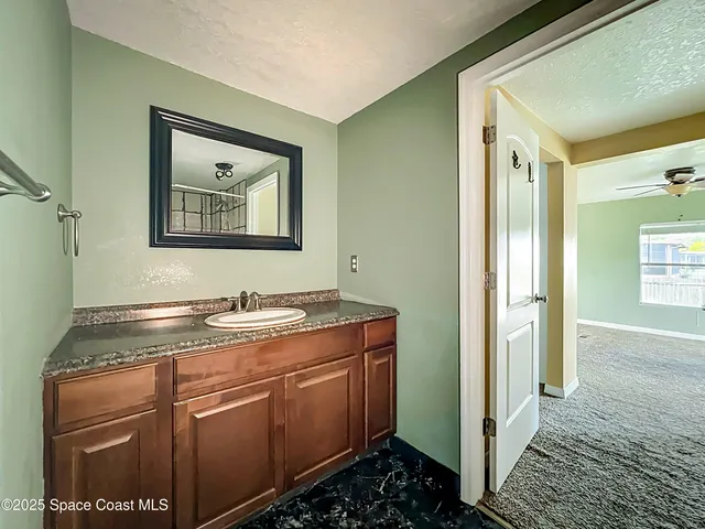 a view of a chair and tables in the patio