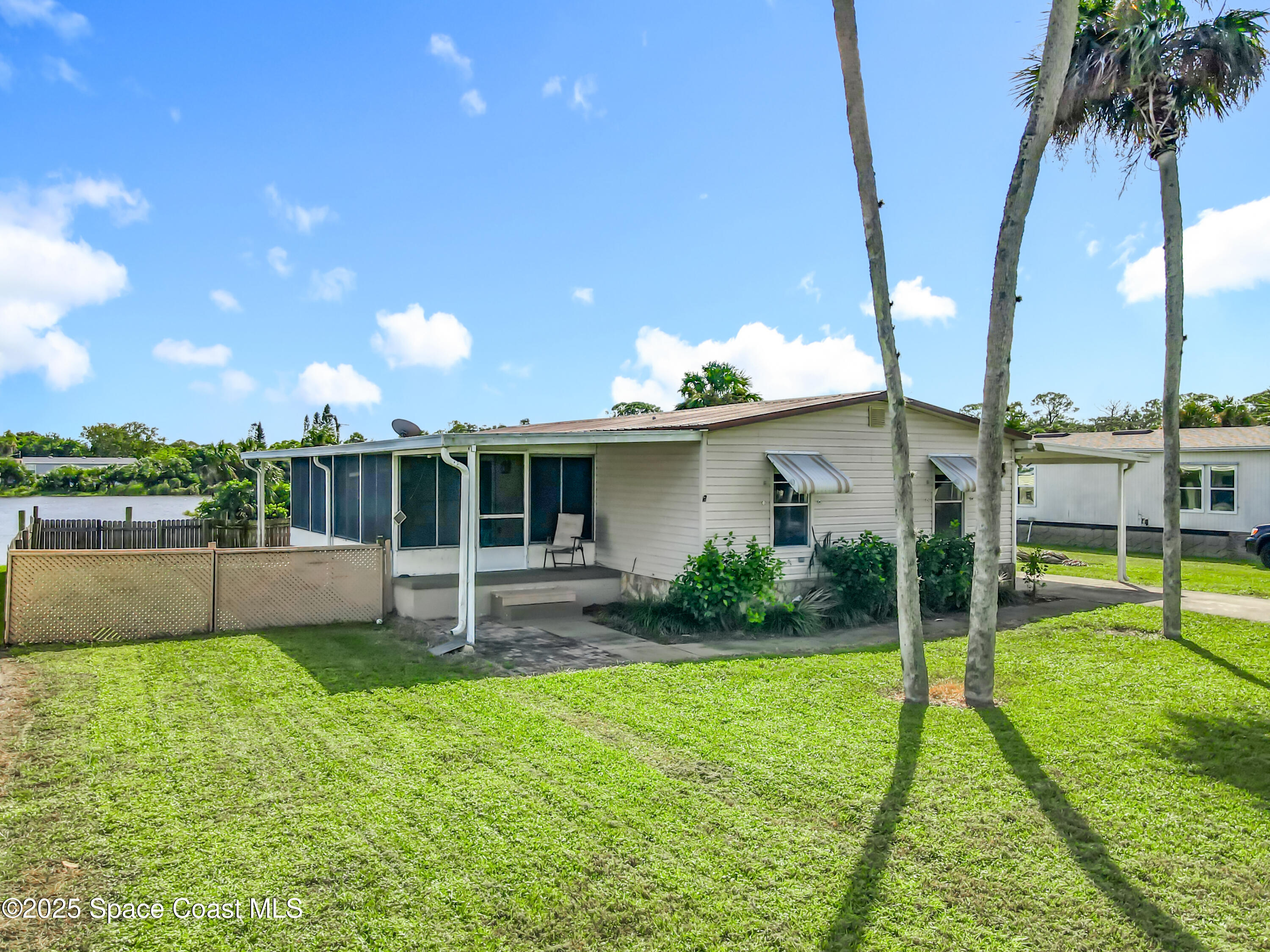 425 Baker Road Merritt Island, FL 32953 - Photo 2 of 27 a house view with a sitting space and garden
