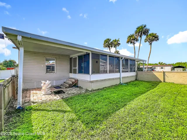 a backyard of a house with lots of green space and lake view