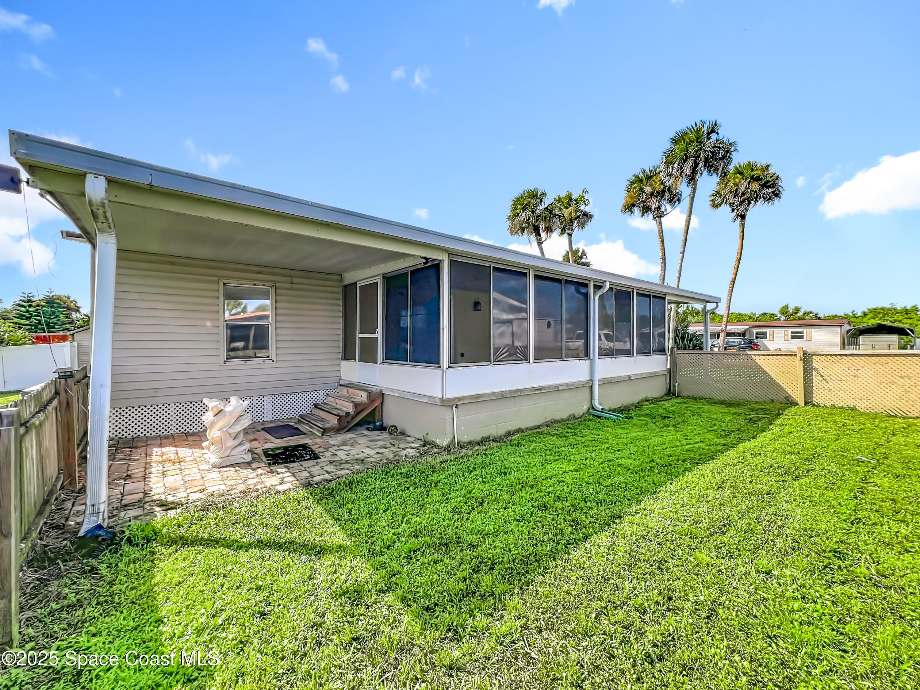 425 Baker Road Merritt Island, FL 32953 - Photo 24 of 27 a view of a chair and table in backyard of the house