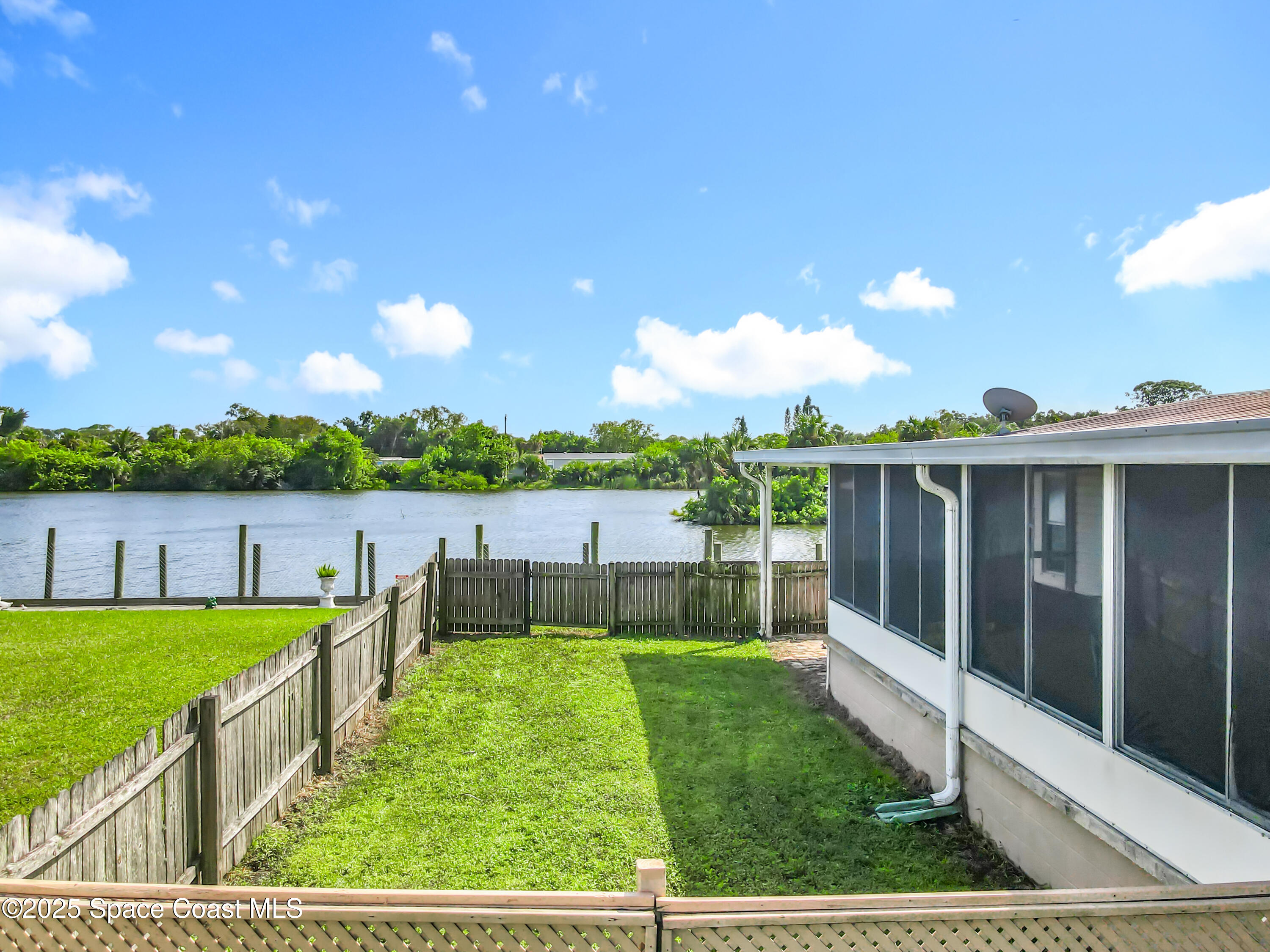 425 Baker Road Merritt Island, FL 32953 - Photo 26 of 27 a view of a garden with lake