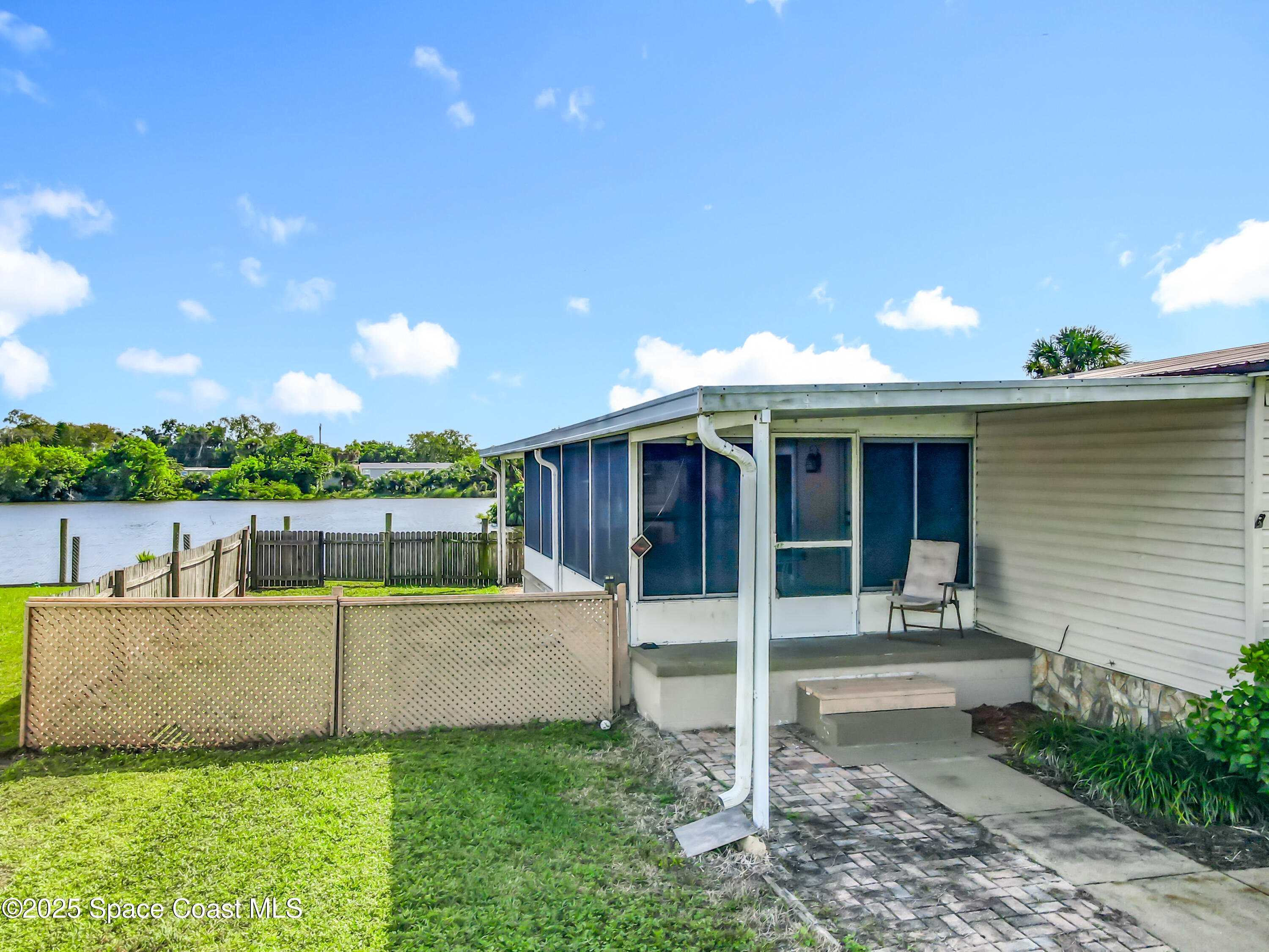 425 Baker Road Merritt Island, FL 32953 - Photo 3 of 27 a view of a house with a yard porch and sitting area