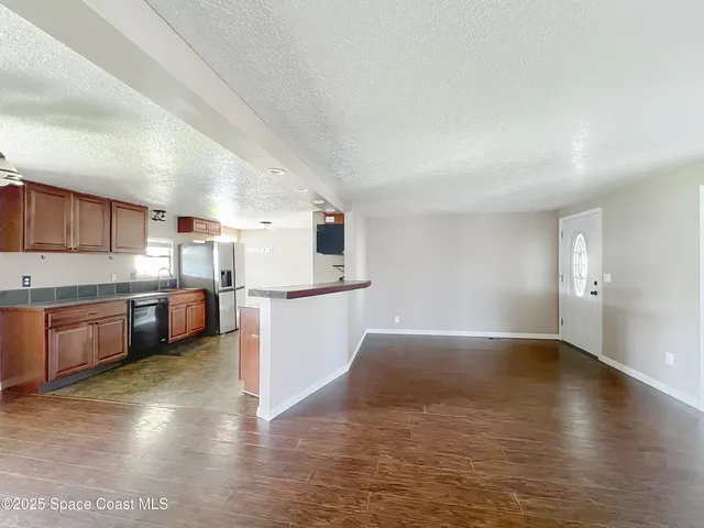 a view of a kitchen with wooden floor