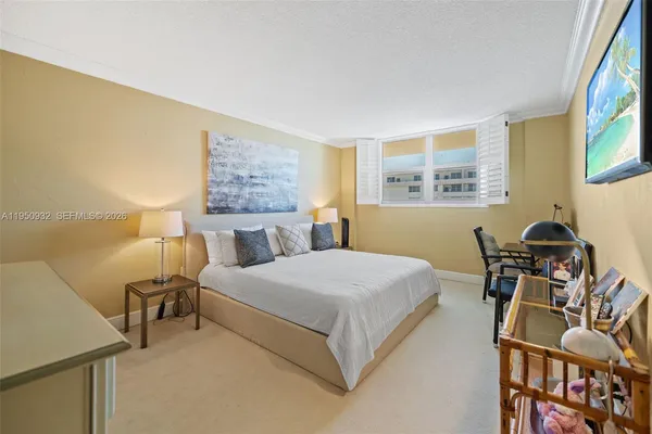 a bed room with a bed and a chair