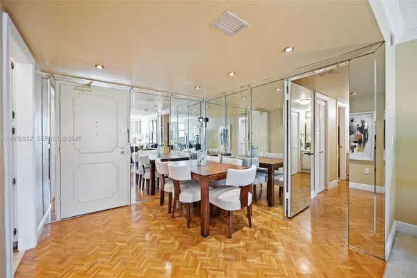 a living room with furniture kitchen view and a large window