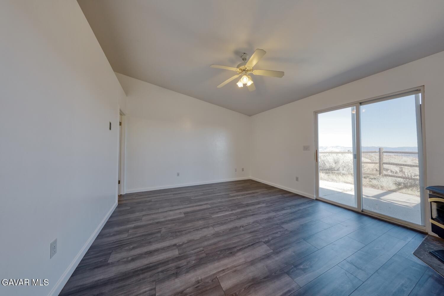 26801 Cabriolet Court Tehachapi, CA 93561 - Photo 21 of 60 an empty room with wooden floor fan and windows