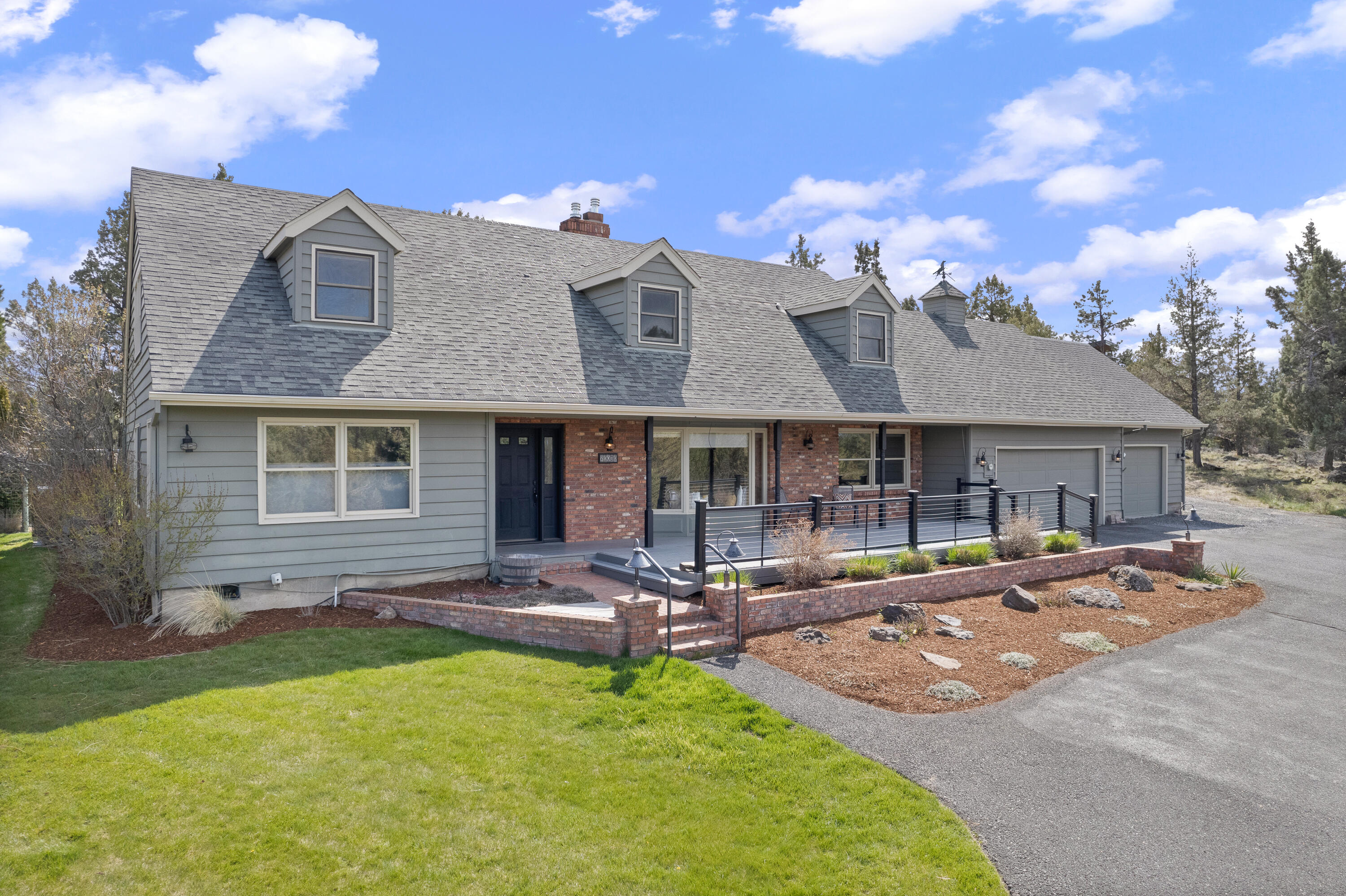 70030 Meadow View Road Sisters, OR 97759 - Photo 34 of 43 a front view of a house with swimming pool and fire pit