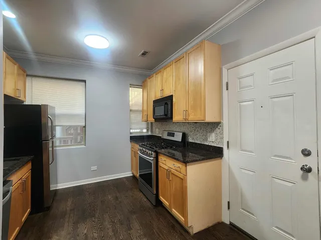 a kitchen with a sink stove and refrigerator