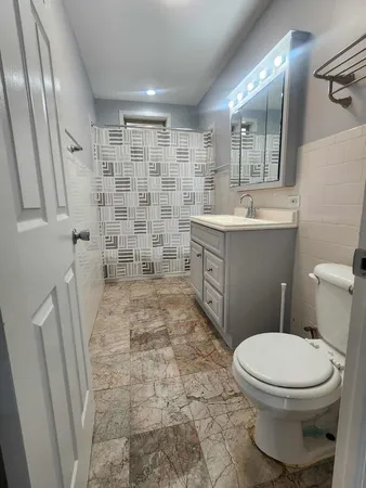 a bathroom with a toilet and a shower