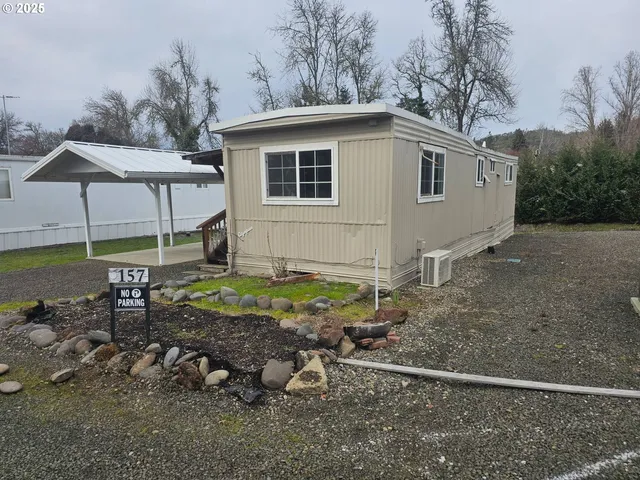 a view of a house with backyard and sitting area