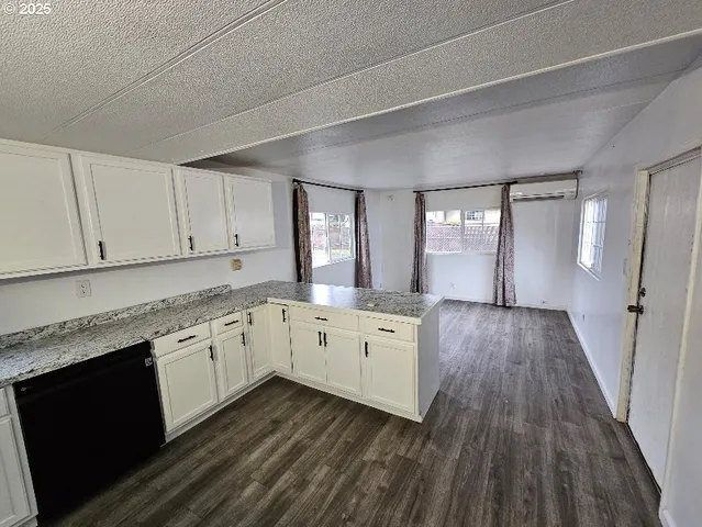 a view of a kitchen counter space and wooden floor