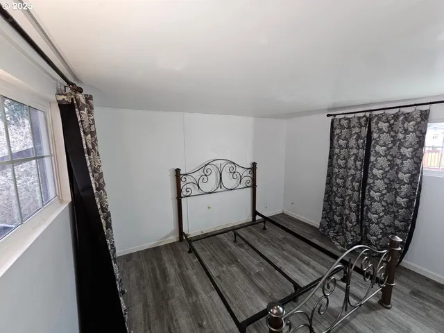 a view of a hardwood floor and an entryway