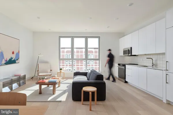 a living room with furniture and floor to ceiling windows