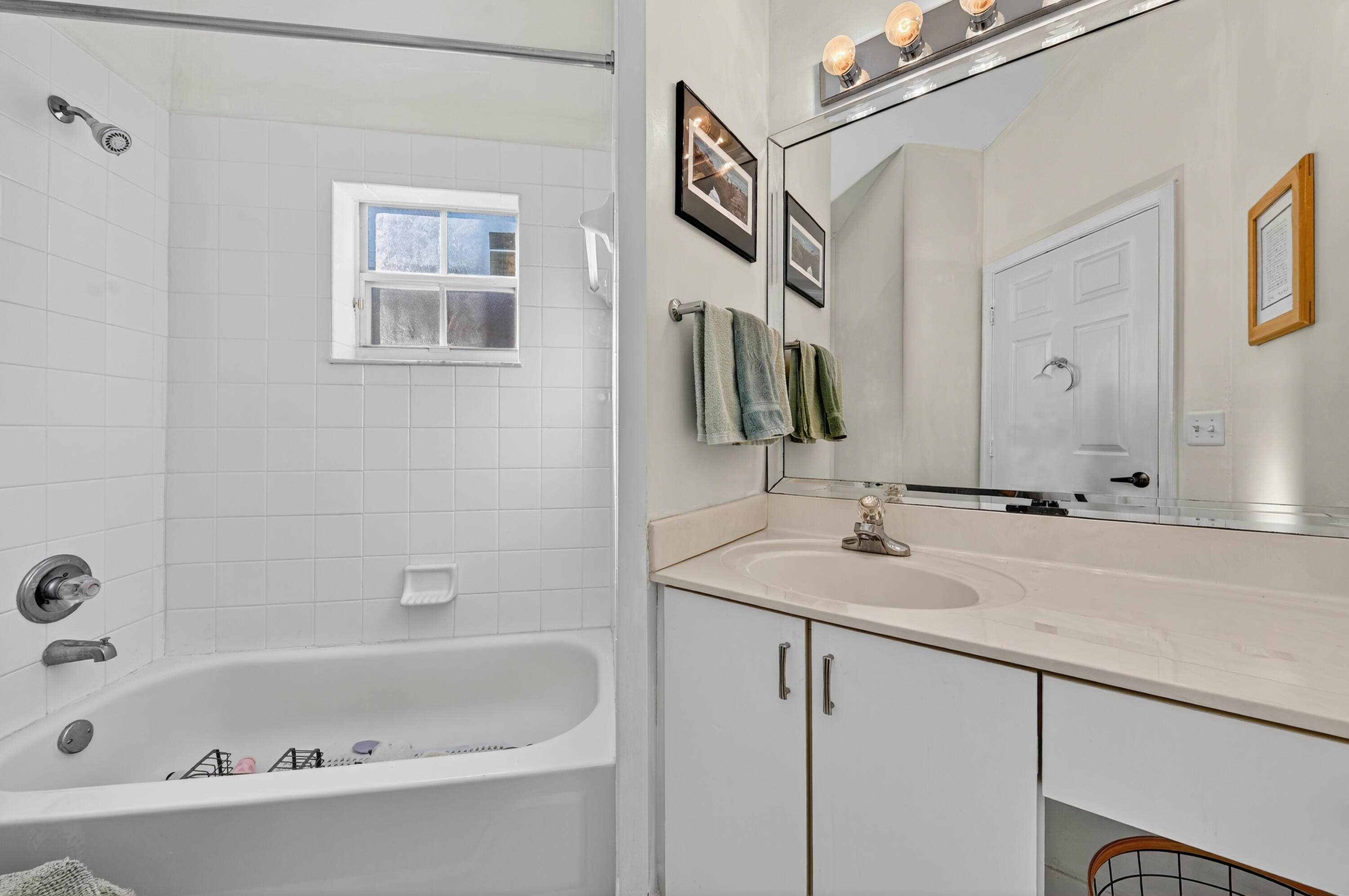 6140 Long Key Lane Boynton Beach, FL 33472 - Photo 11 of 24 a bathroom with a tub sink and mirror