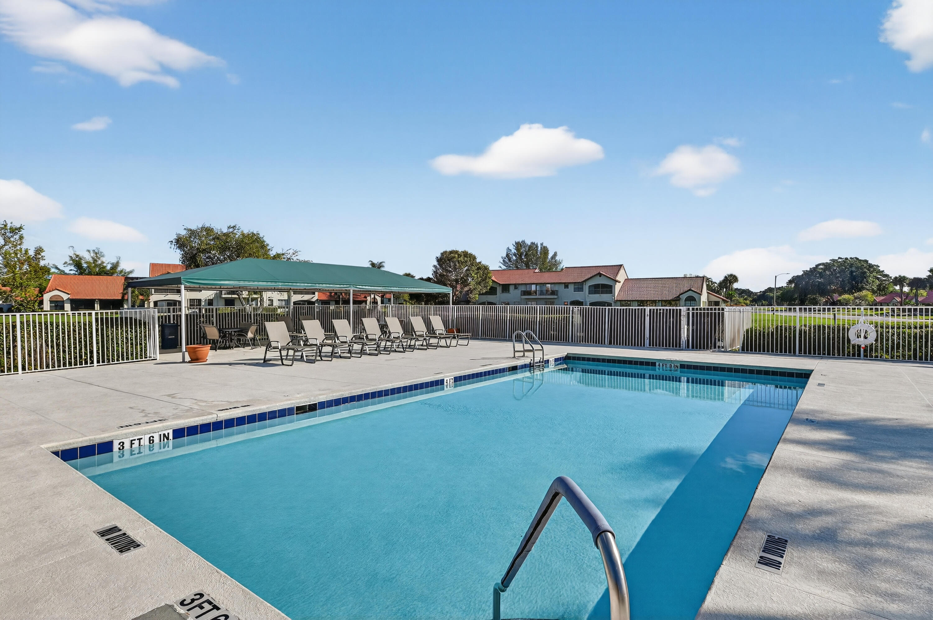 6140 Long Key Lane Boynton Beach, FL 33472 - Photo 15 of 24 a view of a swimming pool with a lounge chairs