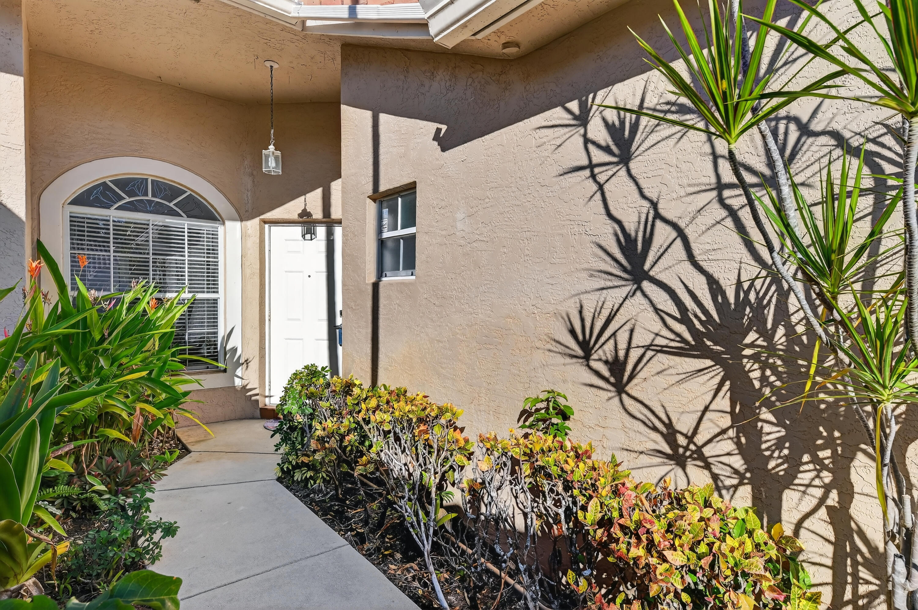 6140 Long Key Lane Boynton Beach, FL 33472 - Photo 2 of 24 a front view of a house with garden