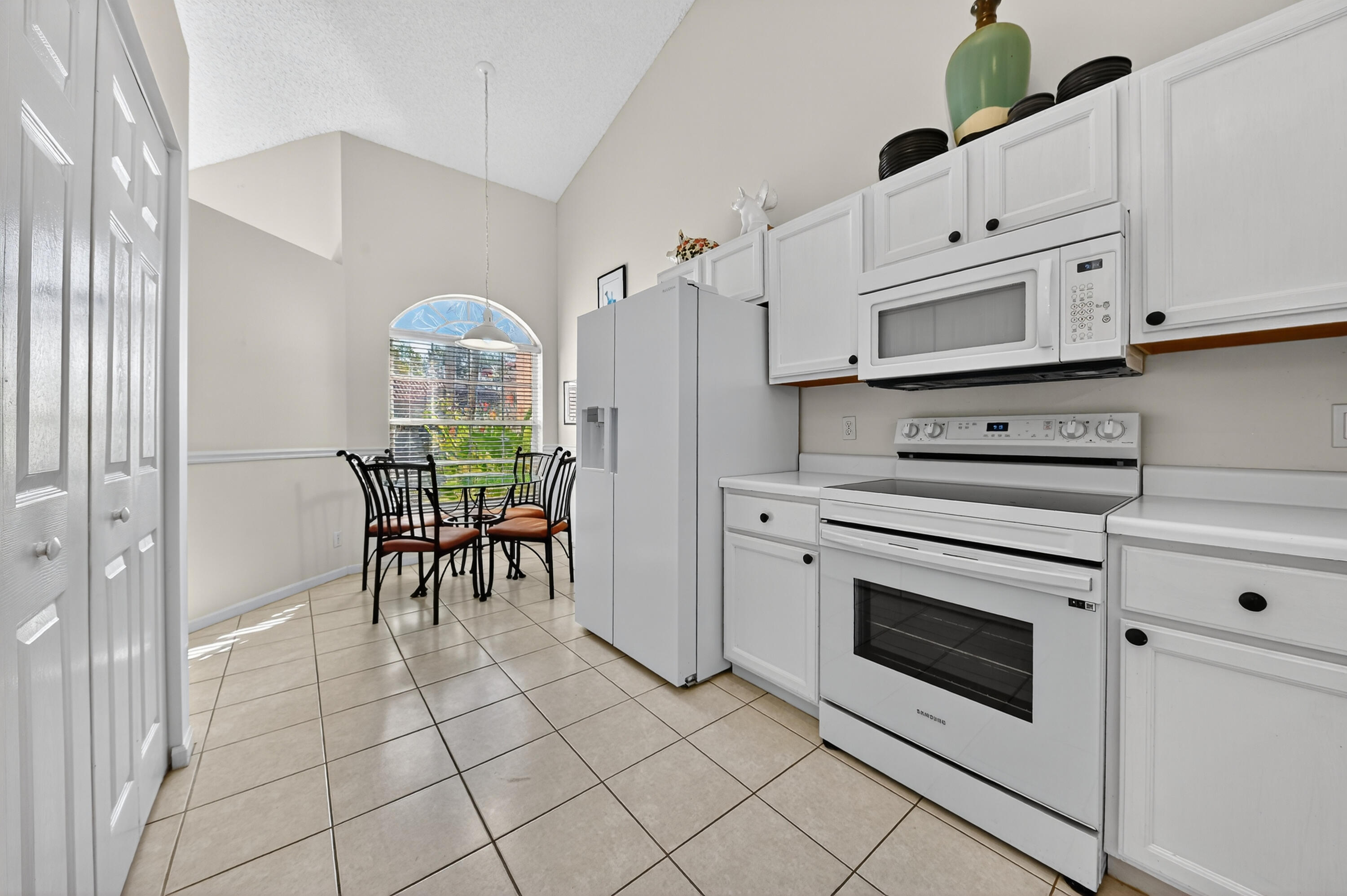 6140 Long Key Lane Boynton Beach, FL 33472 - Photo 4 of 24 a kitchen with appliances cabinets and furniture
