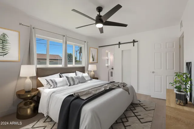 a bed room with a bed and a window